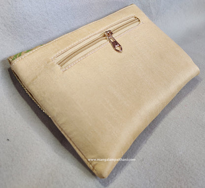 A clutch purse with a floral design and a detachable chain strap in gold color.