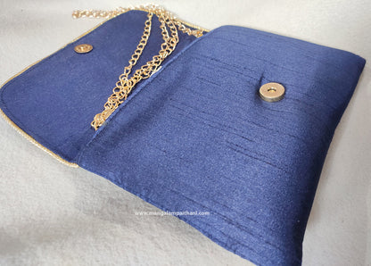 purse with a floral design and a detachable gold chain strap.