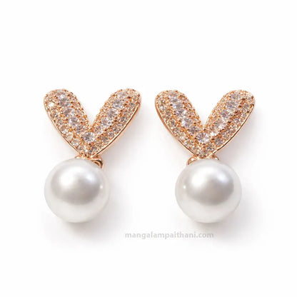 Rose gold pearl stud earrings with crystal stones