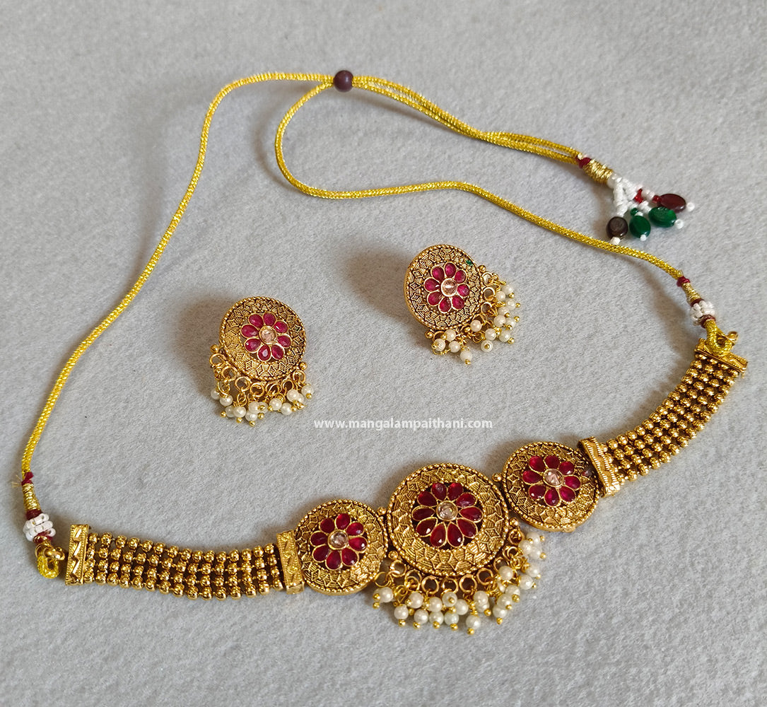 A gold-plated choker necklace set with a red and white floral design, including a necklace and a pair of earrings