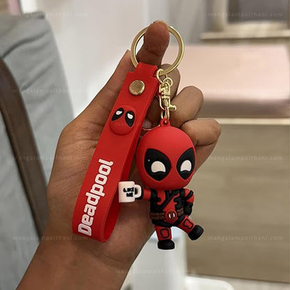 Deadpool keychain held in a hand with a red strap