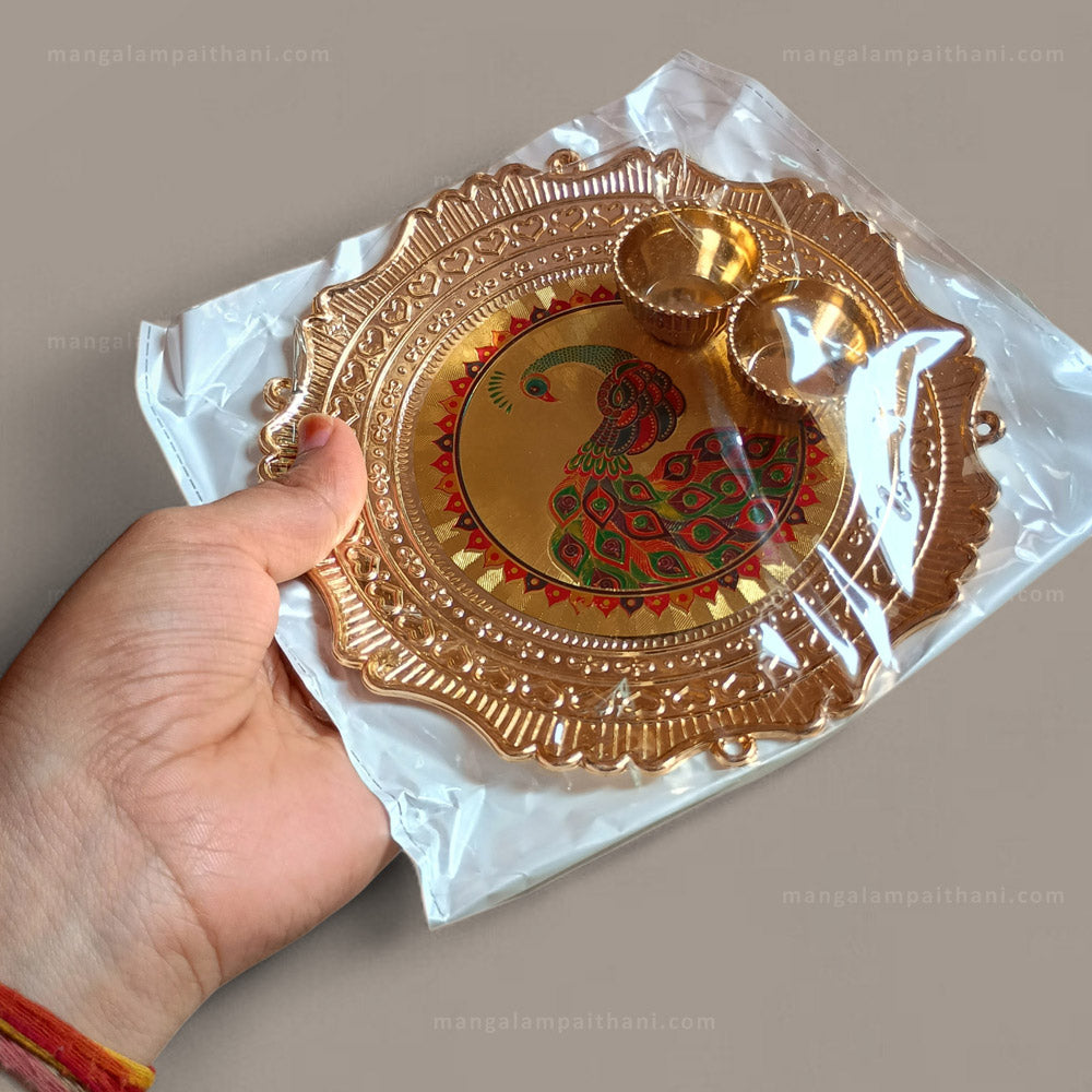 Decorative gold plate with peacock design, mangalam paithani